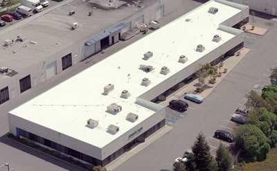 Aerial view of commercial flat roof installation in Denver
